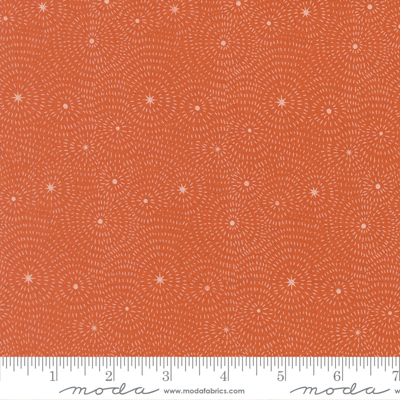 Pattern of concentric circles and stars on a clay background from Night Owl by Gingiber for Moda Fabrics.