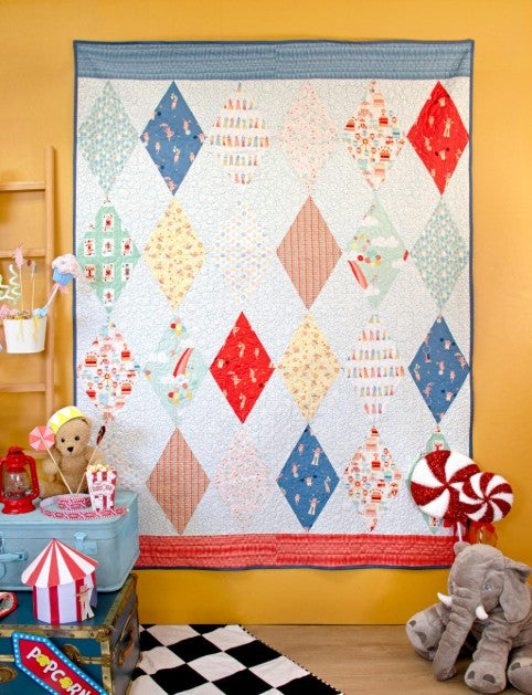 Giggles quilt featuring Purr Parade fabrics by AGF Studio for Art Gallery Fabrics in a colorful diamond quilt design.