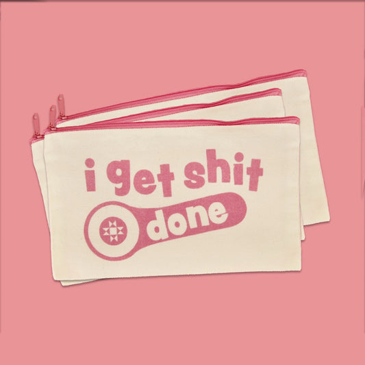 Cream canvas I Get Shit Done zipper pouch with pink lettering and zipper